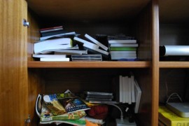 Use photo boxes to organize the media cabinet