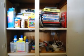 Use photo boxes to organize the media cabinet