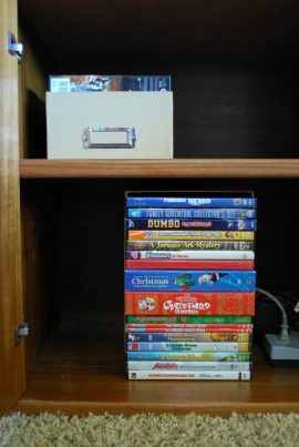 Use photo boxes to organize the media cabinet